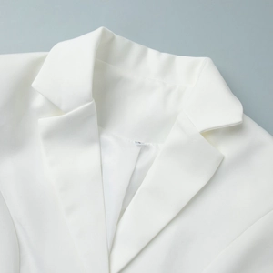 Close-up of white blazer classic notch lapel and textured fabric detail with size tag