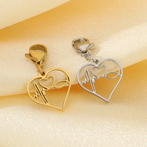 Close-up of heart-shaped hollow pendants with EKG pattern and lobster clasp in gold and silver