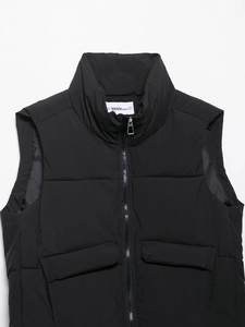 Detail shot of the stand collar and shoulder stitching on a black padded vest with zipper
