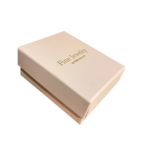 Detailed view of cream jewelry gift box with gold Fine Jewelry foil stamping and lid detail