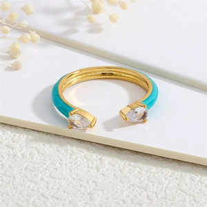 Detailed macro view of 18K gold-plated adjustable ring with cyan enamel and drop-shaped zircon