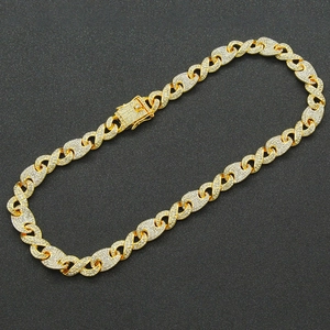Detailed view of a gold-plated Cuban link necklace with iced-out infinity links and box clasp