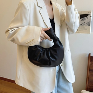 Minimalist black pleated knot dumpling handbag in premium faux leather for casual wear