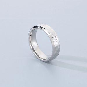 Macro shot of silver titanium steel ring featuring a unique hammered texture finish