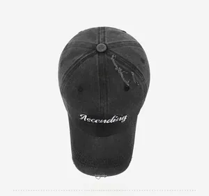 Top view of distressed denim baseball cap with Ascending embroidery and ripped details