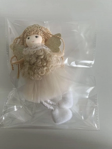 Close-up of a handmade angel doll ornament with wings for Christmas tree decoration