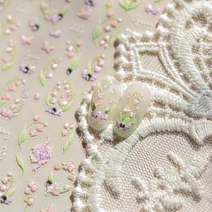 3D lily of the valley nail art stickers with pink floral designs on white lace background