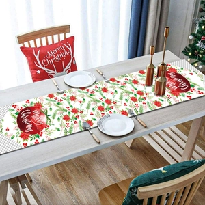 Detail of Christmas table runner with Merry Christmas lettering on a wooden dining table