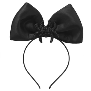 Detail of black satin bow headband with glitter spider ornament for Halloween party