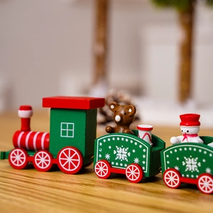 Close-up of a wooden Christmas train with a cute snowman and bear in festive red and green