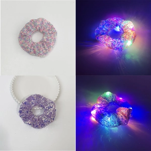 Detailed comparison of pink and purple sequin LED hair scrunchies in light and dark