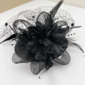 Close-up of vintage black mesh fascinator with delicate feathers and bead detailing