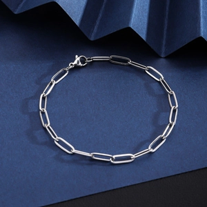 Macro shot of silver stainless steel Cuban link chain with a secure lobster clasp closure