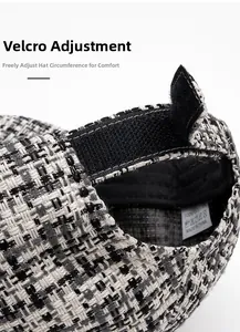 Detail of adjustable velcro strap on black and white plaid tweed baseball cap back