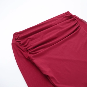 Detailed close-up of red pleated mesh fabric showing elegant draping and texture