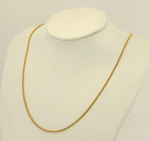 Detail of 18K gold-plated 304 stainless steel box chain necklace on a model's neck