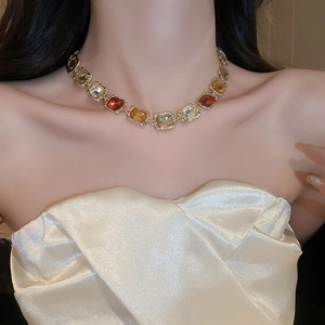 Close-up of vintage geometric necklace with colorful square stones on model