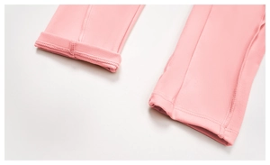 Detail of pink brushed yoga jumpsuit showing reinforced double stitching and hem finish