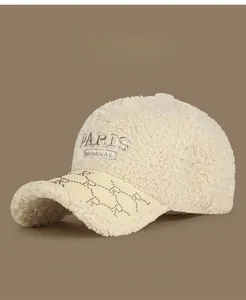 Detail of lamb wool baseball cap with Paris embroidery and rhinestone trim finish