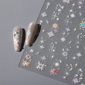 Holographic snowflake and star nail stickers with shiny finish on grey glitter nails