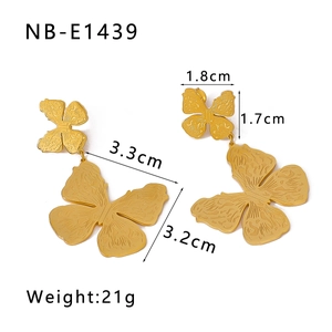 Detail of gold double butterfly earrings with textured finish and precise dimensions