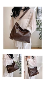 Close-up of brown PU leather tote bag featuring gold pendant and wide shoulder strap