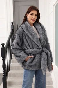 Detail of grey faux fur coat with waist belt and wide lapels shown in close-up texture