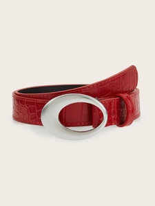 Close-up of red crocodile embossed leather belt with a silver oval metal buckle