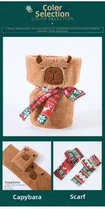 Macro shot of Capybara plush warmer with festive red and green plaid scarf detail