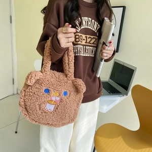 Detail of cute brown faux shearling bear handbag with embroidery and 3D ears