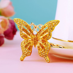 Close-up of butterfly keychain with yellow crystals and golden finish details