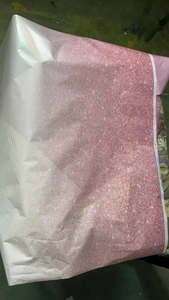 Close-up detail of gradient pink party tablecloth with sparkling purple glitter dots