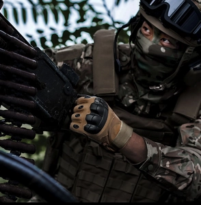 Tactical gloves detail with knuckle protection during professional field operation