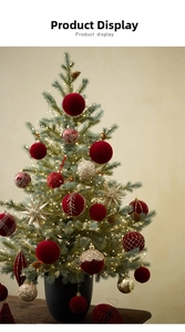 Close-up of red velvet and gold glitter Christmas ornaments hanging on a green tree