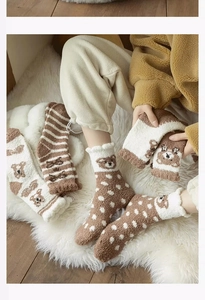 Close-up of fluffy bear pattern coral fleece socks with cute brown and white details