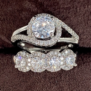 Luxury silver bridal ring set with round cut center diamond and paved band in jewelry box
