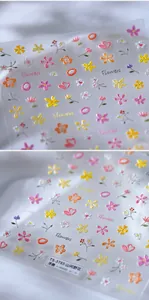 Macro shot of 3D embossed floral nail stickers featuring colorful mountain wildflowers