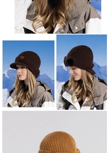 Detail of warm winter knitted beanie with goggles and visor in outdoor snowy mountains