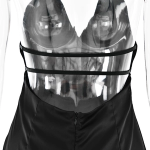 Detail view of the black satin dress featuring thin back straps and a hidden zipper closure