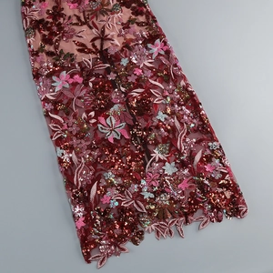 Detailed embroidery and sequins on wine red mesh fabric with elegant floral patterns