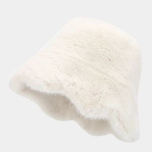 Close-up of the thick faux fur texture and brim detail on a cream white winter bucket hat