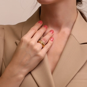 18K gold plated stainless steel wide band ring with a central pearl on a hand