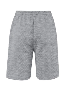 Close-up of grey waffle knit fabric shorts with elastic waist and textured detail