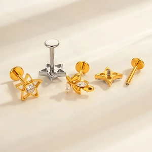 F136 titanium piercing studs with star and leaf designs in gold and silver finish