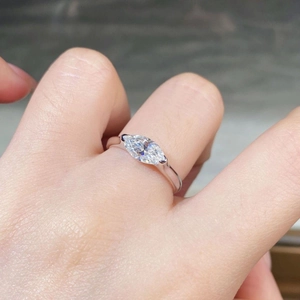 Detail shot of a 925 sterling silver ring with a marquise-cut moissanite on a finger