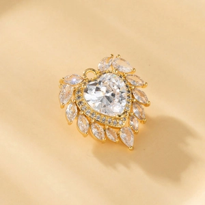Elegant gold heart pendant with zircon inlay and teardrop accents on warm background