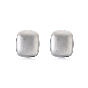 Detailed macro shot of silver square geometric stud earrings with brushed metal texture
