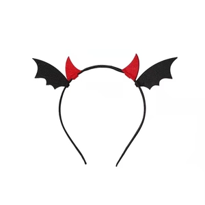 Detail of Halloween headband with red devil horns and black felt bat wings on white background