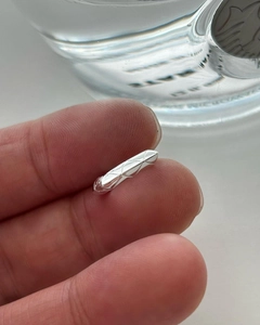 Minimalist 925 sterling silver quilted pattern earrings shown held by hand