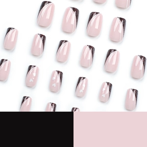 Short square pink press-on nails with black glitter tips and white heart patterns